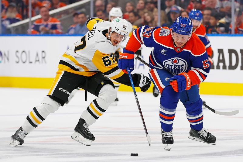 Oct 25, 2024; Edmonton, Alberta, CAN; Pittsburgh Penguins forward Rickard Rakell (67) tries to knock the puck away from Edmonton Oilers forward Jeff Skinner (53) during the third period at Rogers Place. Mandatory Credit: Perry Nelson-Imagn Images