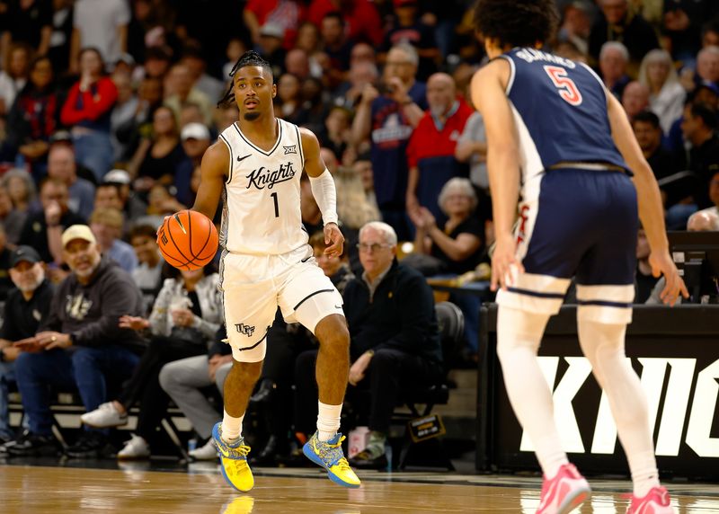 Jan 17, 2026; Orlando, Florida, USA;  Central Florida Knights guard Themus Fulks (1) dribbles up the court in the first half against the Arizona Wildcats at Addition Financial Arena. Mandatory Credit: Russell Lansford-Imagn Images