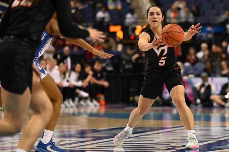 Mar 4, 2023; Greensboro, NC, USA; Virginia Tech Hokies guard Georgia Amoore (5) passes to center Clara Ford (32) during the first half at Greensboro Coliseum. Mandatory Credit: William Howard-USA TODAY Sports