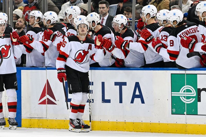 Dec 2, 2024; New York, New York, USA;  New Jersey Devils center Jack Hughes (86) celebrates his goal with teammates against the New York Rangers during the second period at Madison Square Garden. Mandatory Credit: Dennis Schneidler-Imagn Images