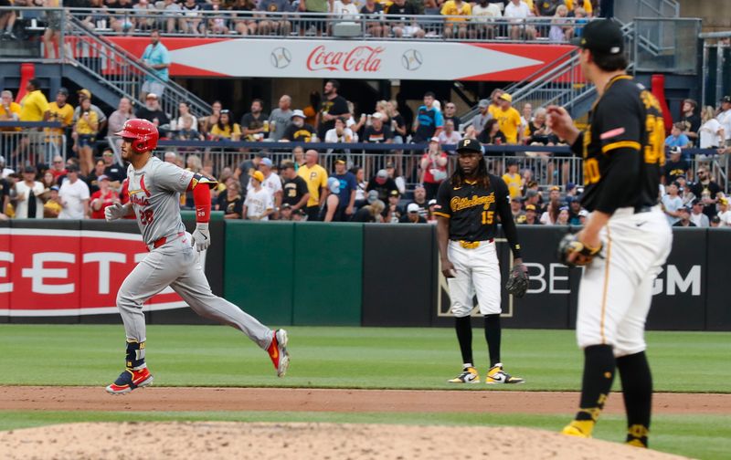 Jul 23, 2024; Pittsburgh, Pennsylvania, USA;  Pittsburgh Pirates shortstop Oneil Cruz (15) and starting pitcher Paul Skenes (30) watch as St. Louis Cardinals third baseman Nolan Arenado (28) circles the bases on a solo home run during the fifth inning at PNC Park. Mandatory Credit: Charles LeClaire-USA TODAY Sports