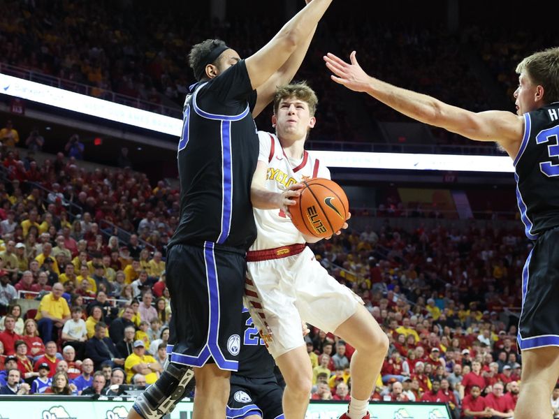 Mar 6, 2024; Ames, Iowa, USA; Brigham Young Cougars center Aly Khalifa (50) defends Iowa State Cyclones guard Jackson Paveletzke (1) at James H. Hilton Coliseum. Mandatory Credit: Reese Strickland-USA TODAY Sports

