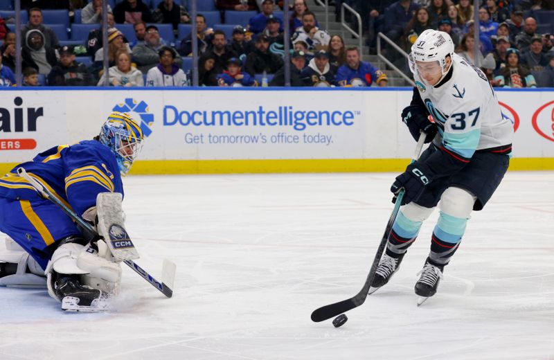 Jan 9, 2024; Buffalo, New York, USA;  Seattle Kraken center Yanni Gourde (37) looks to take a shot on Buffalo Sabres goaltender Devon Levi (27) during the third period at KeyBank Center. Mandatory Credit: Timothy T. Ludwig-USA TODAY Sports