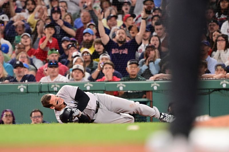 Jun 16, 2024; Boston, Massachusetts, USA; New York Yankees first baseman Anthony Rizzo (48) trips on Boston Red Sox pitcher Brennan Bernardino (not pictured) and rolls on the ground during the seventh inning at Fenway Park. Mandatory Credit: Eric Canha-USA TODAY Sports