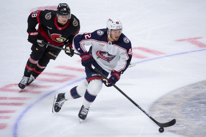 Feb 13, 2024; Ottawa, Ontario, CAN; Ottawa Senators center Tim Stutzle (18) chases Columbus Blue Jackets  center Alexandre Texier (42) who controls the puck in the third period at the Canadian Tire Centre. Mandatory Credit: Marc DesRosiers-USA TODAY Sports