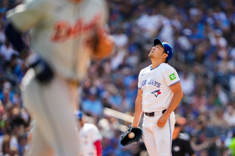 Jul 20, 2024; Toronto, Ontario, CAN; Toronto Blue Jays pitcher Yusei Kikuchi (16) walks Detroit Tigers first base Mark Canha (21) during the sixth inning at Rogers Centre. Mandatory Credit: Kevin Sousa-USA TODAY Sports