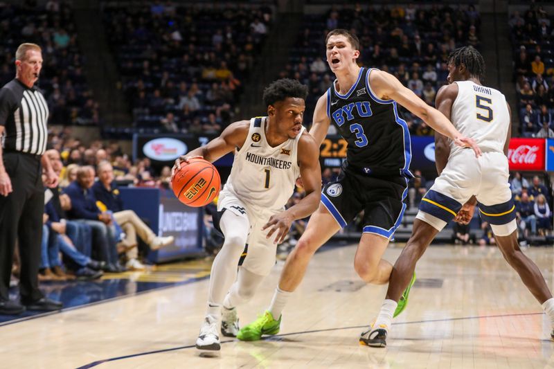 Feb 11, 2025; Morgantown, West Virginia, USA; West Virginia Mountaineers guard Joseph Yesufu (1) dribbles past Brigham Young Cougars guard Egor Demin (3) during the first half at WVU Coliseum. Mandatory Credit: Ben Queen-Imagn Images