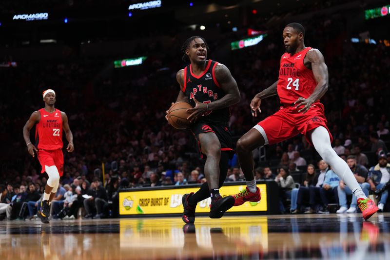 MIAMI, FLORIDA - DECEMBER 12: Davion Mitchell #45 of the Toronto Raptors drives to the basket against Haywood Highsmith #24 of the Miami Heat during the third quarter at Kaseya Center on December 12, 2024 in Miami, Florida. NOTE TO USER: User expressly acknowledges and agrees that, by downloading and or using this Photograph, user is consenting to the terms and conditions of the Getty Images License Agreement. (Photo by Rich Storry/Getty Images)