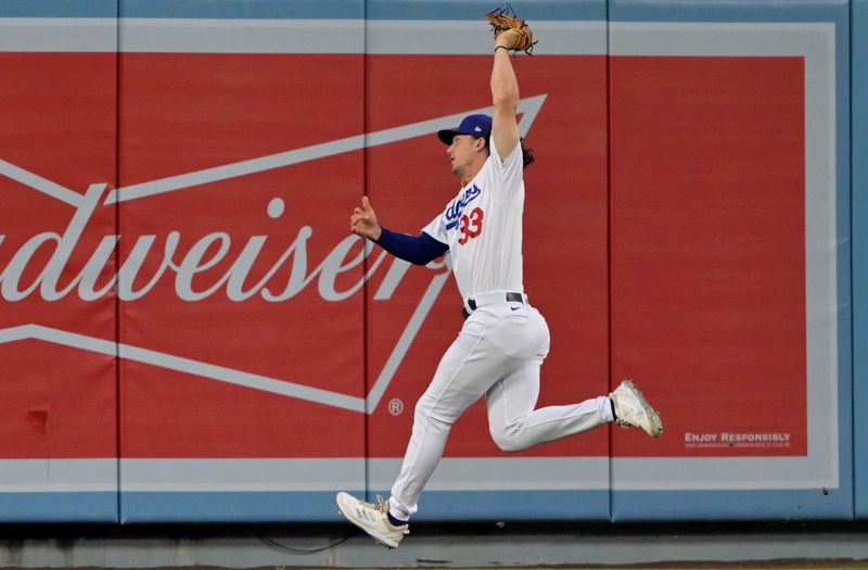 Aug 17, 2023; Los Angeles, California, USA;  Los Angeles Dodgers center fielder James Outman (33) makes a running catch for an out off Milwaukee Brewers second baseman Andruw Monasterio (14) in the second inning at Dodger Stadium. Mandatory Credit: Jayne Kamin-Oncea-USA TODAY Sports