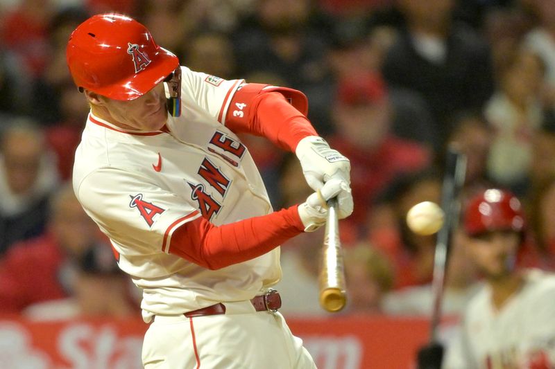 Sep 17, 2024; Anaheim, California, USA;  Los Angeles Angels third baseman Eric Wagaman (34) hits a solo home run in the sixth inning against the Chicago White Sox at Angel Stadium. Mandatory Credit: Jayne Kamin-Oncea-Imagn Images