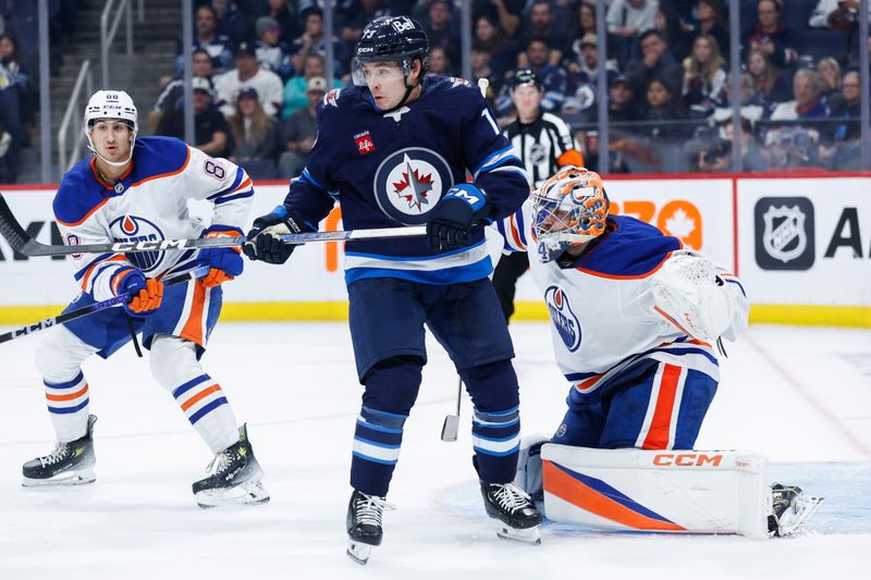 Sep 25, 2024; Winnipeg, Manitoba, CAN; Winnipeg Jets forward Parker Ford (73) screens Edmonton Oilers goalie Stuart Skinner (74) during the second period at Canada Life Centre. Mandatory Credit: Terrence Lee-Imagn Images