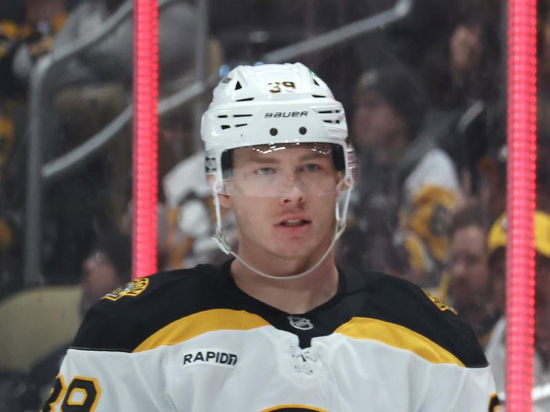 Apr 13, 2025; Pittsburgh, Pennsylvania, USA;  Boston Bruins center Morgan Geekie (39) reacts after scoring a goal against the Pittsburgh Penguins during the second period at PPG Paints Arena. Mandatory Credit: Charles LeClaire-Imagn Images