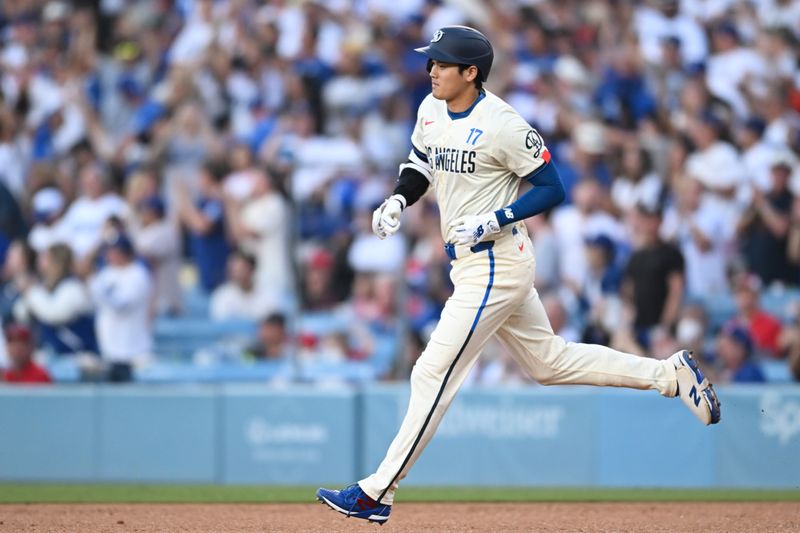 Jun 22, 2024; Los Angeles, California, USA; Los Angeles Dodgers designated hitter Shohei Ohtani (17) hits a home run against the Los Angeles Angels during the third inning at Dodger Stadium. Mandatory Credit: Jonathan Hui-USA TODAY Sports