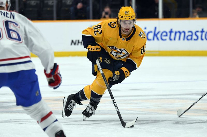 Mar 5, 2024; Nashville, Tennessee, USA; Nashville Predators center Tommy Novak (82) skates the puck across center ice during the first period against the Montreal Canadiens at Bridgestone Arena. Mandatory Credit: Christopher Hanewinckel-USA TODAY Sports