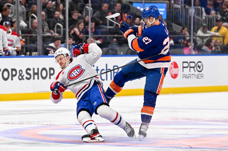 Apr 11, 2024; Elmont, New York, USA; Montreal Canadiens left wing Michael Pezzetta (55) and New York Islanders left wing Anders Lee (27) collide on center ice during the third period at UBS Arena. Mandatory Credit: Dennis Schneidler-USA TODAY Sports