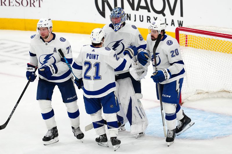 Mar 19, 2024; Las Vegas, Nevada, USA; Tampa Bay Lightning center Brayden Point (21) congratulates Tampa Bay Lightning goaltender Andrei Vasilevskiy (88) after the Lightning defeated the Vegas Golden Knights 5-3 at T-Mobile Arena. Mandatory Credit: Stephen R. Sylvanie-USA TODAY Sports