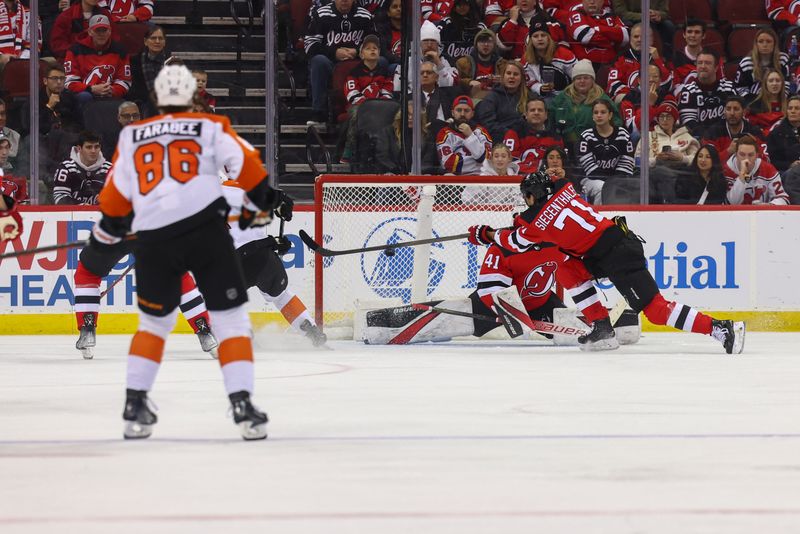 Dec 19, 2023; Newark, New Jersey, USA; Philadelphia Flyers center Ryan Poehling (25) scores a goal on New Jersey Devils goaltender Vitek Vanecek (41) during the second period at Prudential Center. Mandatory Credit: Ed Mulholland-USA TODAY Sports