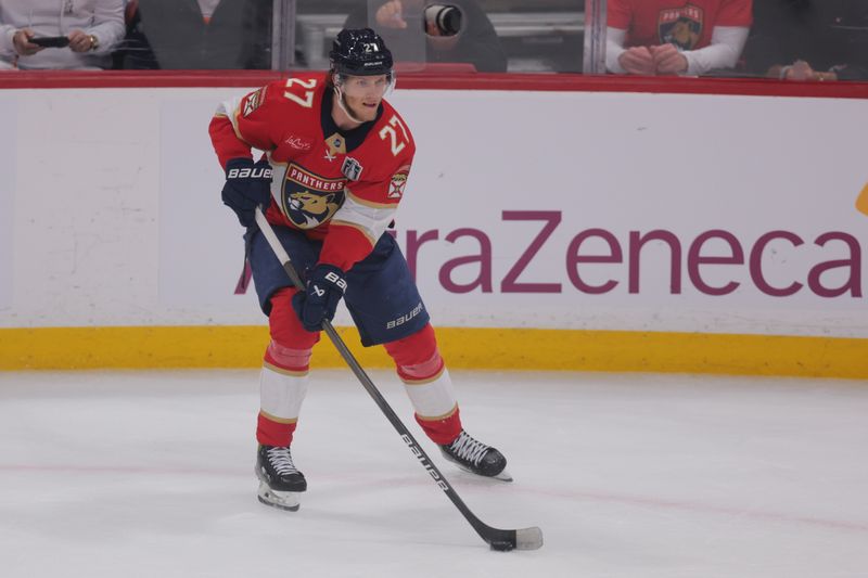 Jun 9, 2025; Sunrise, Florida, USA; Florida Panthers forward Eetu Luostarinen (27) controls the puck  during the second period against the Edmonton Oilers  in game three of the 2025 Stanley Cup Final at Amerant Bank Arena. Mandatory Credit: Sam Navarro-Imagn Images