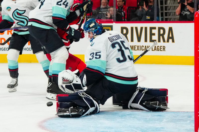 Oct 26, 2023; Raleigh, North Carolina, USA; Seattle Kraken goaltender Joey Daccord (35) makes a pad save against the Carolina Hurricanes during the first period at PNC Arena. Mandatory Credit: James Guillory-USA TODAY Sports