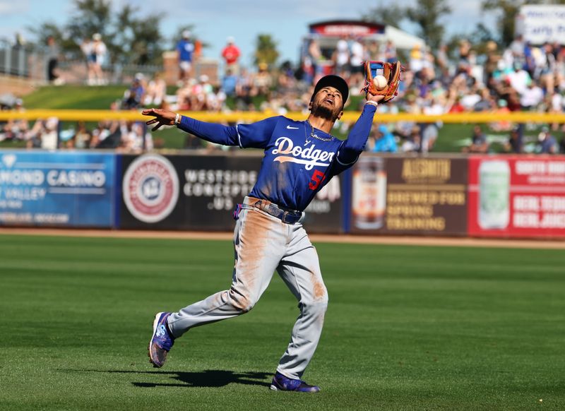 Feb 22, 2024; Peoria, Arizona, USA; Los Angeles Dodgers second baseman Mookie Betts catches a fly ball against the San Diego Padres during a spring training game at Peoria Sports Complex. Mandatory Credit: Mark J. Rebilas-USA TODAY Sports