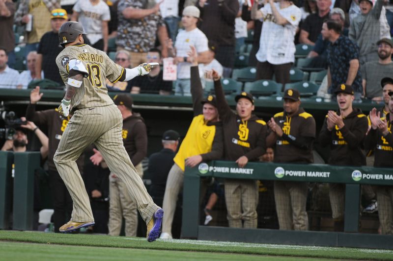 Apr 8, 2025; West Sacramento, California, USA; San Diego Padres third base Manny Machado (13) points to his team mates after hitting a home run against the Athletics during the first inning at Sutter Health Park. Mandatory Credit: Ed Szczepanski-Imagn Images