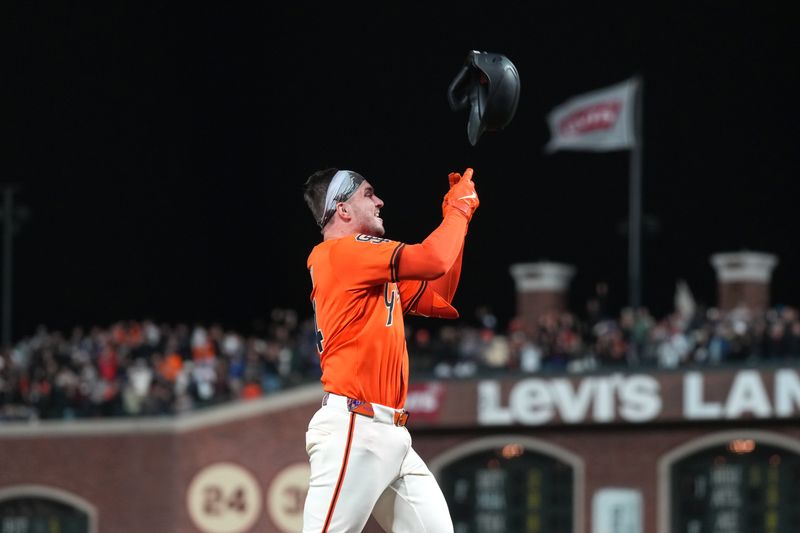 Sep 12, 2025; San Francisco, California, USA; San Francisco Giants catcher Patrick Bailey (14) tosses his helmet while rousing the bases after hitting a walk off grand slam home run against the Los Angeles Dodgers during the tenth inning at Oracle Park. Mandatory Credit: Darren Yamashita-Imagn Images