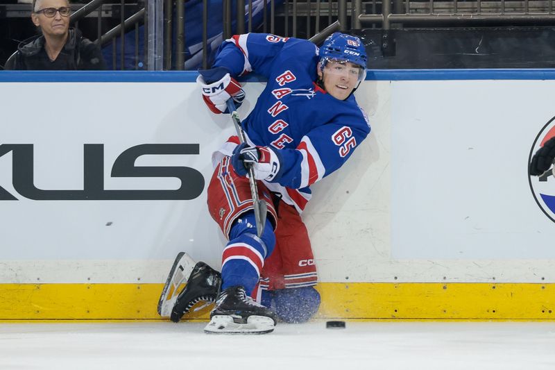 Sep 23, 2025; New York, New York, USA; New York Rangers left wing Brett Berard (65) plays the puck during the first period of a preseason game against the Boston Bruins at Madison Square Garden. Mandatory Credit: Vincent Carchietta-Imagn Images