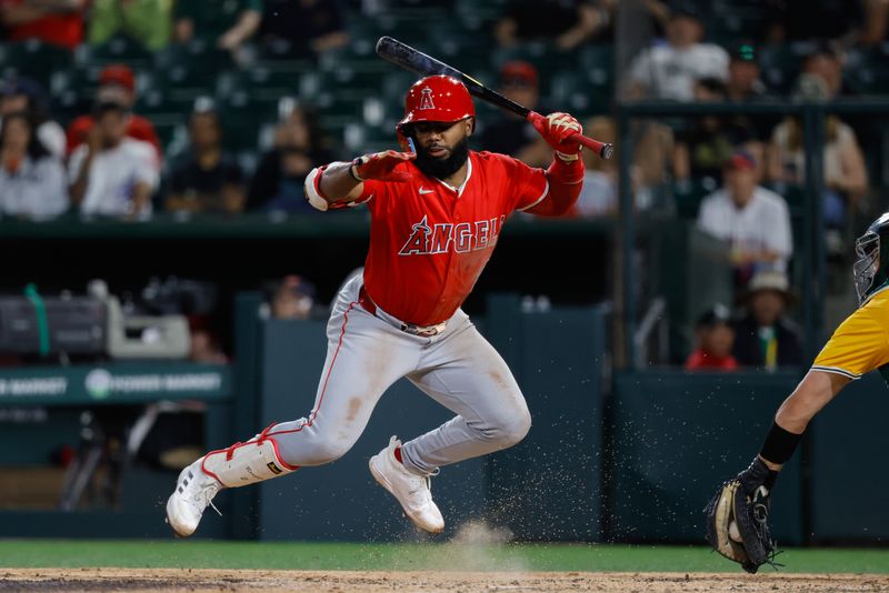 May 20, 2025; West Sacramento, California, USA; Los Angeles Angels second baseman Luis Rengifo (2) jumps to avoid a wild pitch during the sixth inning against the Athletics at Sutter Health Park. Mandatory Credit: Sergio Estrada-Imagn Images