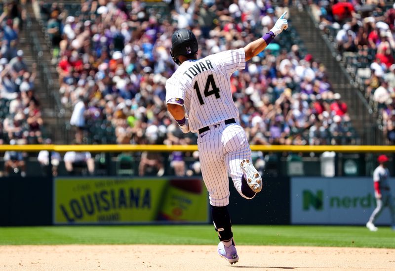 Jun 25, 2023; Denver, Colorado, USA; Colorado Rockies shortstop Ezequiel Tovar (14) runs off a solo home run in the against the Los Angeles Angels at Coors Field. Mandatory Credit: Ron Chenoy-USA TODAY Sports