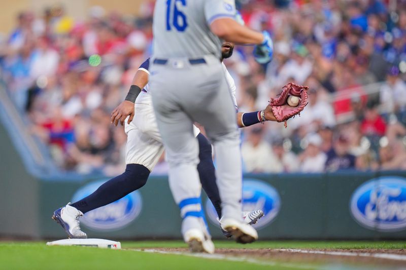 Aug 12, 2024; Minneapolis, Minnesota, USA; Minnesota Twins first base Carlos Santana (30) catches the ball for an out against the Kansas City Royals outfielder Hunter Renfroe (16) in the sixth inning at Target Field. Mandatory Credit: Brad Rempel-USA TODAY Sports