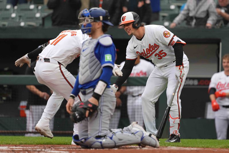 May 15, 2024; Baltimore, Maryland, USA; Baltimore Orioles third baseman Justin Westburg (11) greeted by designated hitter Adley Rutschman (35) after hitting a solo home run in the first inning at Oriole Park at Camden Yards. Mandatory Credit: Mitch Stringer-USA TODAY Sports