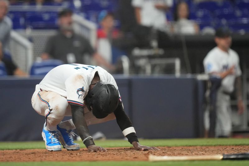 Jun 17, 2024; Miami, Florida, USA;  Miami Marlins left fielder Nick Gordon (1) takes a moment after getting tagged out at home plate in the 12th inning by St. Louis Cardinals catcher Pedro Pagés (43) at loanDepot Park. Mandatory Credit: Jim Rassol-USA TODAY Sports