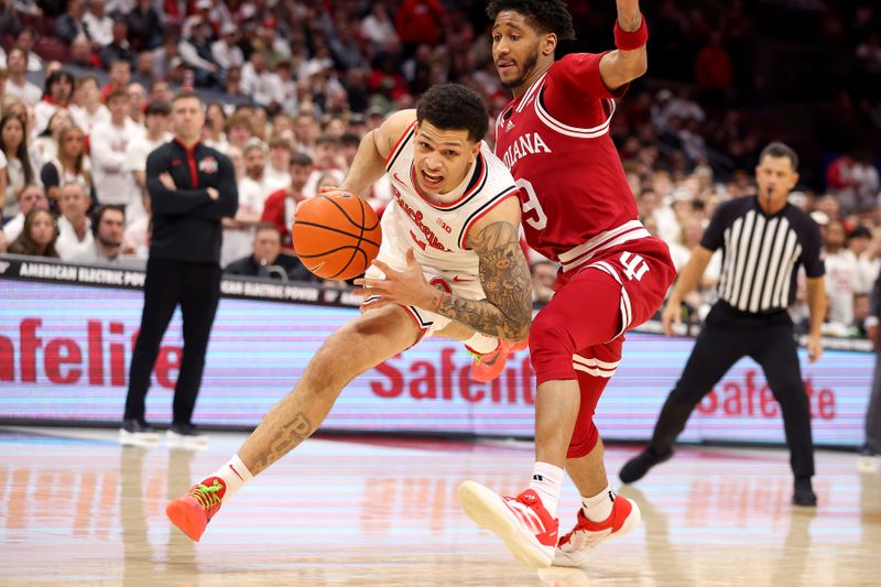 Jan 17, 2025; Columbus, Ohio, USA; Ohio State Buckeyes guard John Mobley Jr. (0) drives to the basket as Indiana Hoosiers guard Kanaan Carlyle (9) defends during the second half at Value City Arena. Mandatory Credit: Joseph Maiorana-Imagn Images