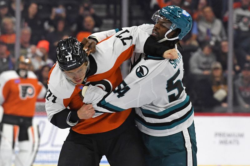 Nov 11, 2024; Philadelphia, Pennsylvania, USA; Philadelphia Flyers defenseman Erik Johnson (77) and San Jose Sharks right wing Givani Smith (54) fight during the first period at Wells Fargo Center. Mandatory Credit: Eric Hartline-Imagn Images