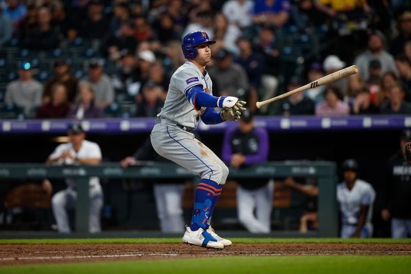 May 26, 2023; Denver, Colorado, USA; New York Mets center fielder Brandon Nimmo (9) tosses his bat on a walk in the sixth inning against the Colorado Rockies at Coors Field. Mandatory Credit: Isaiah J. Downing-USA TODAY Sports