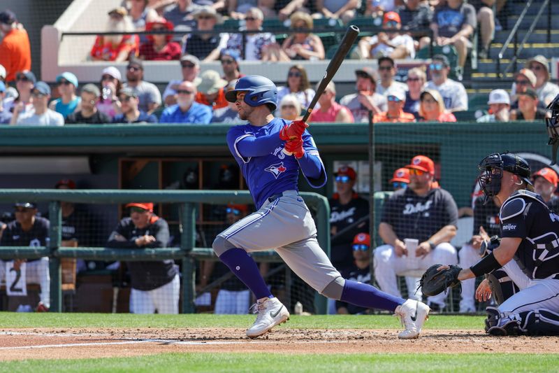 Mar 3, 2025; Lakeland, Florida, USA; Toronto Blue Jays third baseman Ernie Clement (22) hits a single during the third inning against the Detroit Tigers at Publix Field at Joker Marchant Stadium. Mandatory Credit: Mike Watters-Imagn Images