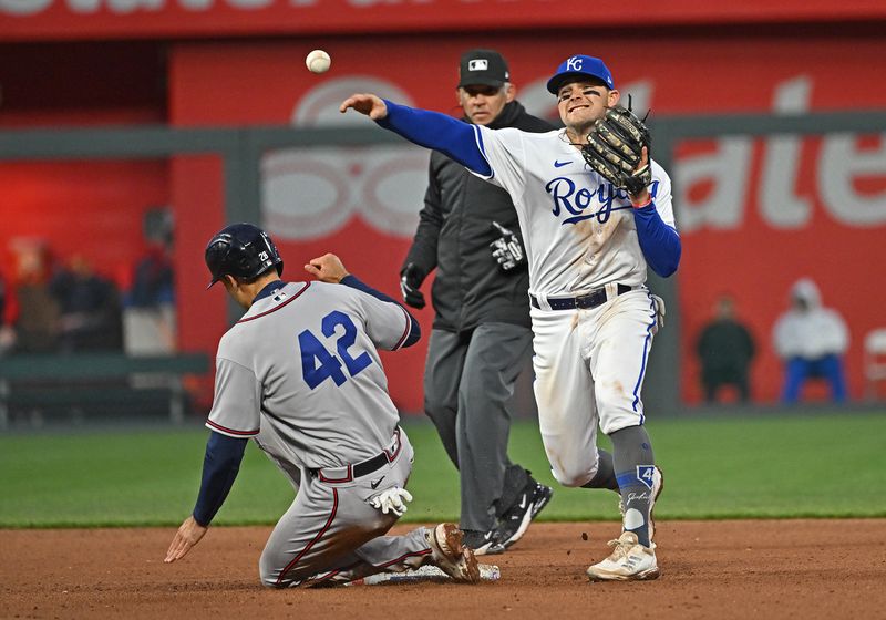 Apr 15, 2023; Kansas City, Missouri, USA;  Kansas City Royals second baseman Michael Massey (19) throws to first base over Atlanta Braves Matt Olson (28) during the seventh inning at Kauffman Stadium. Mandatory Credit: Peter Aiken-USA TODAY Sports