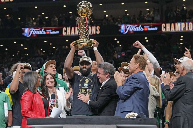 BOSTON, MA - JUNE 17: Jaylen Brown #7 of the Boston Celtics celebrates with the Larry O'Brien Trophy after the game against the Dallas Mavericks during Game 5 of the 2024 NBA Finals on June 17, 2024 at the TD Garden in Boston, Massachusetts. NOTE TO USER: User expressly acknowledges and agrees that, by downloading and or using this photograph, User is consenting to the terms and conditions of the Getty Images License Agreement. Mandatory Copyright Notice: Copyright 2024 NBAE  (Photo by Jesse D. Garrabrant/NBAE via Getty Images)