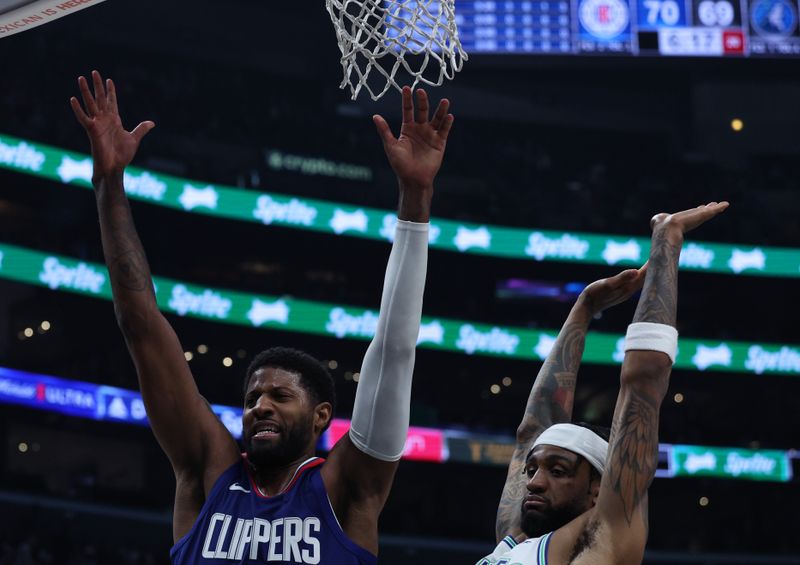 LOS ANGELES, CALIFORNIA - MARCH 12: Paul George #13 of the LA Clippers reacts as he is fouled by Nickeil Alexander-Walker #9 of the Minnesota Timberwolves during a 118-100 Timberwolves win at Crypto.com Arena on March 12, 2024 in Los Angeles, California. (Photo by Harry How/Getty Images)