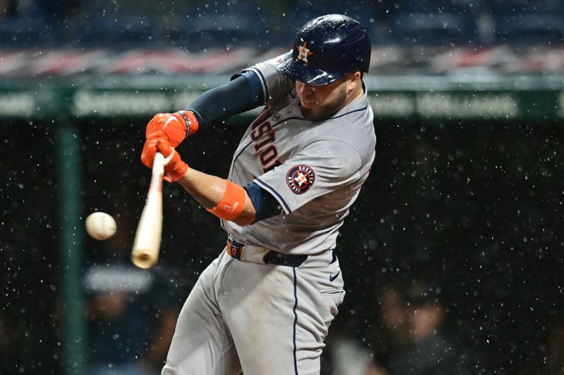 Sep 27, 2024; Cleveland, Ohio, USA; Houston Astros first baseman Victor Caratini (17) hits a home run during the fifth inning against the Cleveland Guardians at Progressive Field. Mandatory Credit: Ken Blaze-Imagn Images