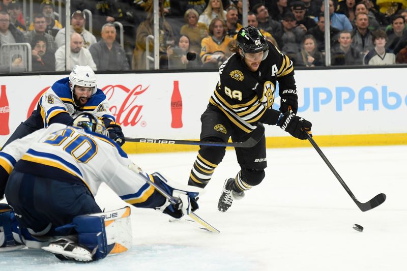 Mar 11, 2024; Boston, Massachusetts, USA;  Boston Bruins right wing David Pastrnak (88) handles the puck in front of St. Louis Blues goaltender Joel Hofer (30) while defenseman Nick Leddy (4) defends during the third period at TD Garden. Mandatory Credit: Bob DeChiara-USA TODAY Sports