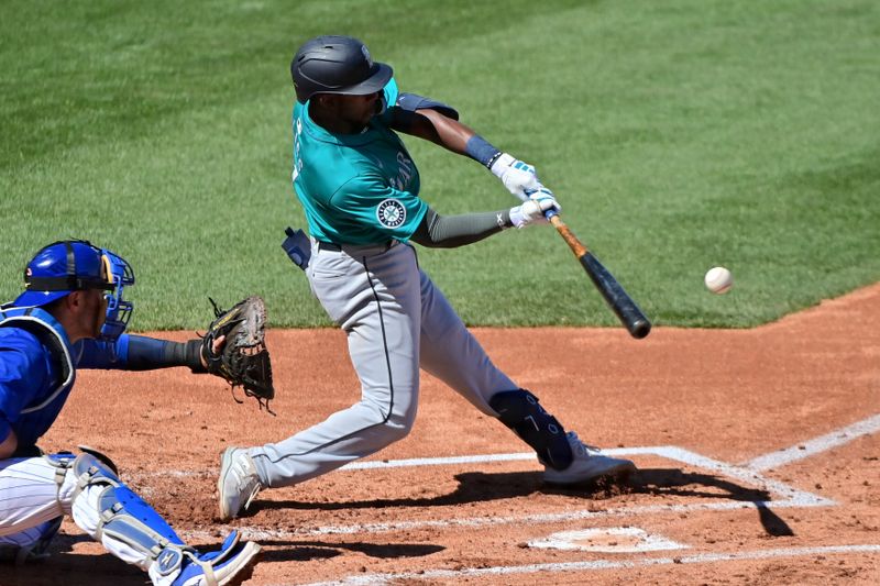 Mar 8, 2024; Mesa, Arizona, USA;  Seattle Mariners shortstop Ryan Bliss (1) hits an RBI single in the second inning against the Chicago Cubs during a spring training game at Sloan Park. Mandatory Credit: Matt Kartozian-USA TODAY Sports