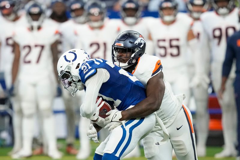 Indianapolis Colts cornerback Dallis Flowers (21) carries the ball against the Denver Broncos during the first half of a preseason NFL football game, Sunday, Aug. 11, 2024, in Westfield, Ind. (AP Photo/Darron Cummings)