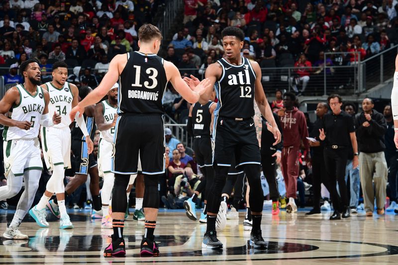 ATLANTA, GA - MARCH 30: Bogdan Bogdanovic #13 and De'Andre Hunter #12 of the Atlanta Hawks high five during the game against the Milwaukee Bucks on March 30, 2024 at State Farm Arena in Atlanta, Georgia.  NOTE TO USER: User expressly acknowledges and agrees that, by downloading and/or using this Photograph, user is consenting to the terms and conditions of the Getty Images License Agreement. Mandatory Copyright Notice: Copyright 2024 NBAE (Photo by Scott Cunningham/NBAE via Getty Images)