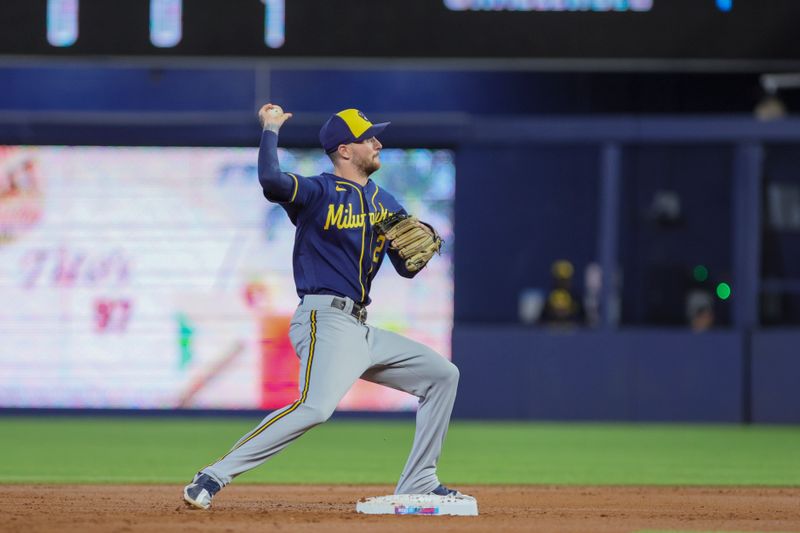 Sep 24, 2023; Miami, Florida, USA; Milwaukee Brewers second baseman Brice Turang (2) turns a double play against the Miami Marlins during the first inning at loanDepot Park. Mandatory Credit: Sam Navarro-USA TODAY Sports