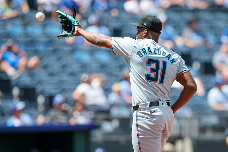 Jun 26, 2024; Kansas City, Missouri, USA; Miami Marlins pitcher Huascar Brazoban (31) catches the ball during the eighth inning against the Kansas City Royals at Kauffman Stadium. Mandatory Credit: William Purnell-USA TODAY Sports