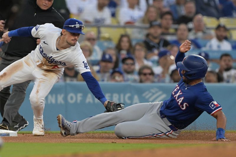 Jun 13, 2024; Los Angeles, California, USA;  Texas Rangers second baseman Marcus Semien (2) is tagged out by Los Angeles Dodgers third baseman Cavan Biggio (6) on an attempted stolen base in the third inning at Dodger Stadium. Mandatory Credit: Jayne Kamin-Oncea-USA TODAY Sports