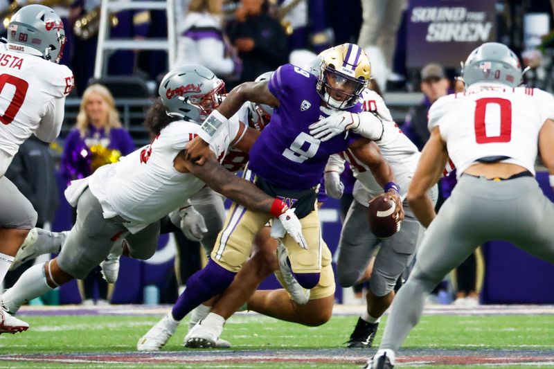 Nov 25, 2023; Seattle, Washington, USA; Washington Huskies quarterback Michael Penix Jr. (9) passes while under pressure from Washington State Cougars defensive lineman Nusi Malani (15) during the fourth quarter at Alaska Airlines Field at Husky Stadium. Mandatory Credit: Joe Nicholson-USA TODAY Sports