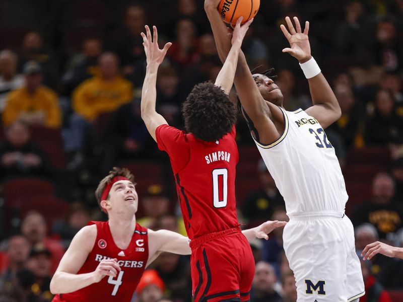 Mar 9, 2023; Chicago, IL, USA; Rutgers Scarlet Knights guard Derek Simpson (0) defends against Michigan Wolverines forward Tarris Reed Jr. (32) during the first half at United Center. Mandatory Credit: Kamil Krzaczynski-USA TODAY Sports