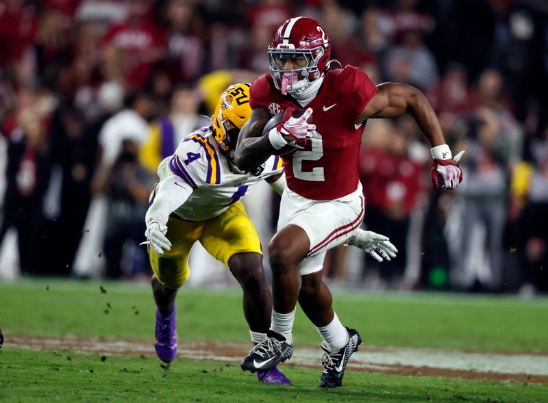 Nov 4, 2023; Tuscaloosa, Alabama, USA; Alabama Crimson Tide running back Jase McClellan (2) carries the ball as LSU Tigers linebacker Harold Perkins Jr. (4) defends during the second half at Bryant-Denny Stadium. Mandatory Credit: Butch Dill-USA TODAY Sports